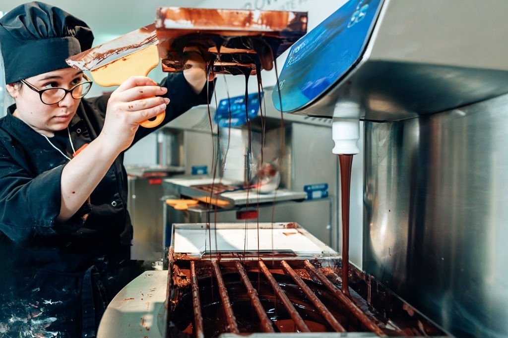 A Brazilian craft chocolate maker making craft chocolate.